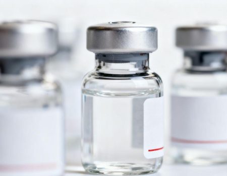 Close-up of peptide vials with clear liquid.