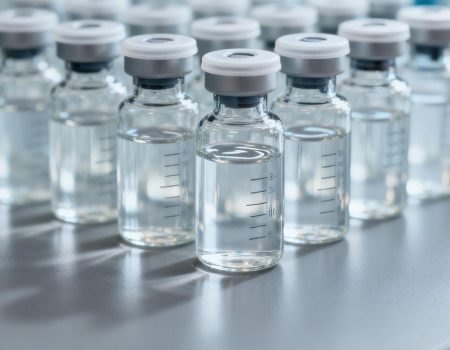 Vials of clear liquid, likely peptides, in a research setting.