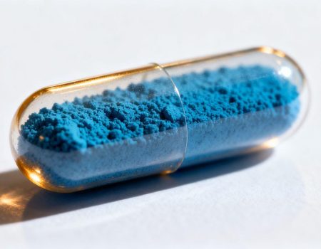 Blue powder in a capsule for GHK-Cu supplement.